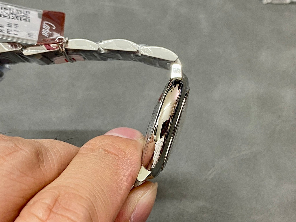 Cartier watch side view with silver case and smooth curved bezel