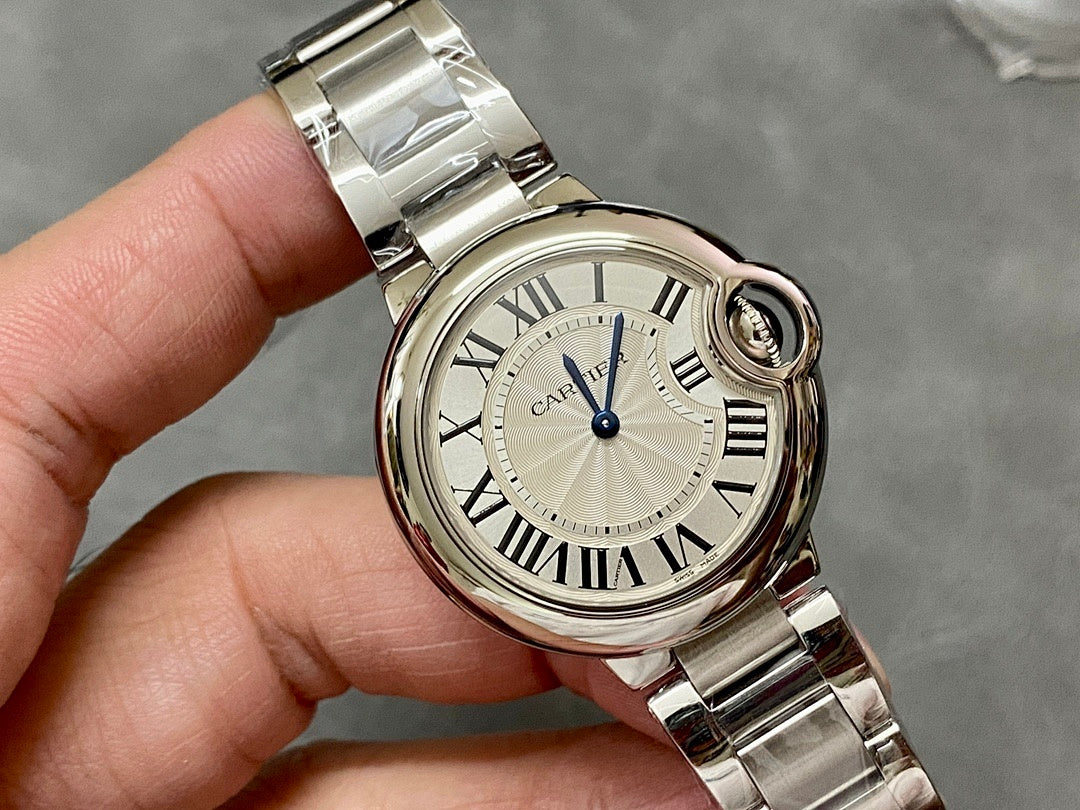 Cartier watch close-up with silver round case, Roman numeral dial and blue seconds hand