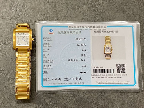 Gold-tone Cartier wristwatch on a display card, square face, metal bracelet