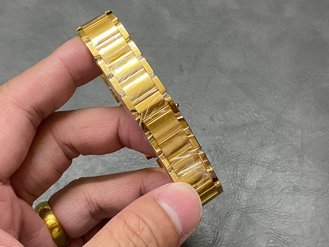 Gold-tone metal bracelet wristwatch with square dial and Roman numerals