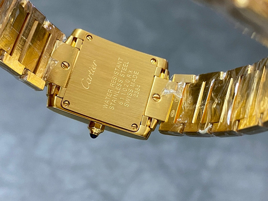Cartier watch caseback with gold-tone hinged metal bracelet and crown detail