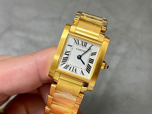 Gold-tone Cartier wristwatch with square face, Roman numerals, and metal bracelet