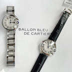 Flat-lay view of two wristwatches: stainless steel bracelet and black leather strap.