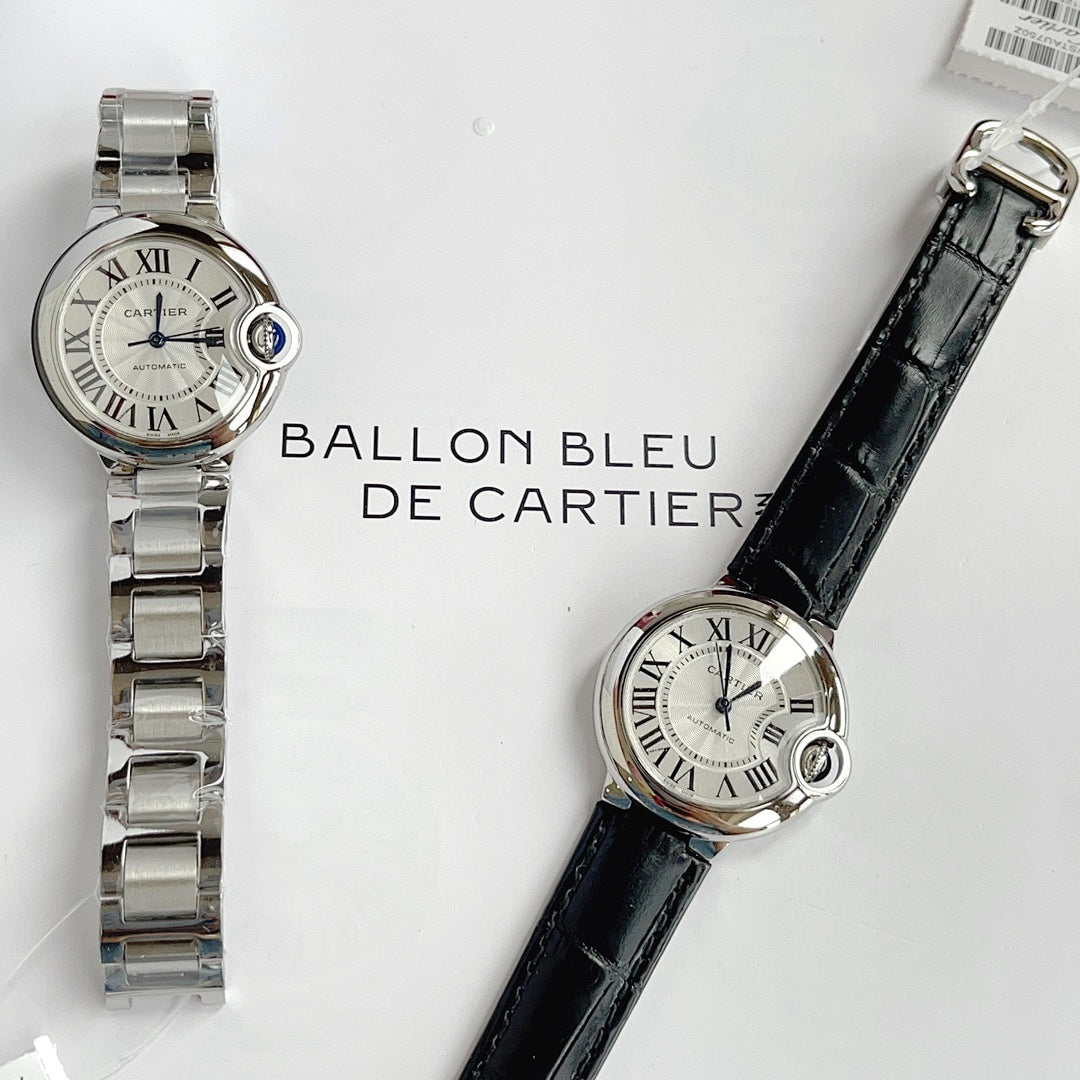 Flat-lay view of two wristwatches: stainless steel bracelet and black leather strap.