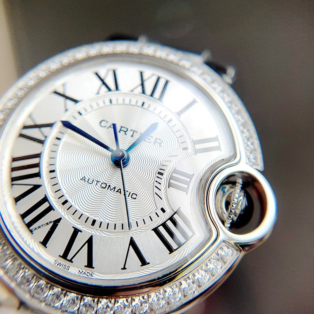 Cartier Ballon Bleu watch close-up: white dial, blue hands, diamond-studded bezel