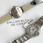 Cartier Ballon Bleu watch with silver link bracelet, white dial, blue hands, diamond bezel