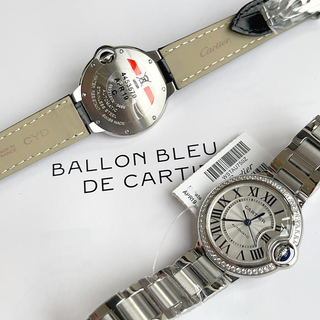 Cartier Ballon Bleu watch with silver link bracelet, white dial, blue hands, diamond bezel