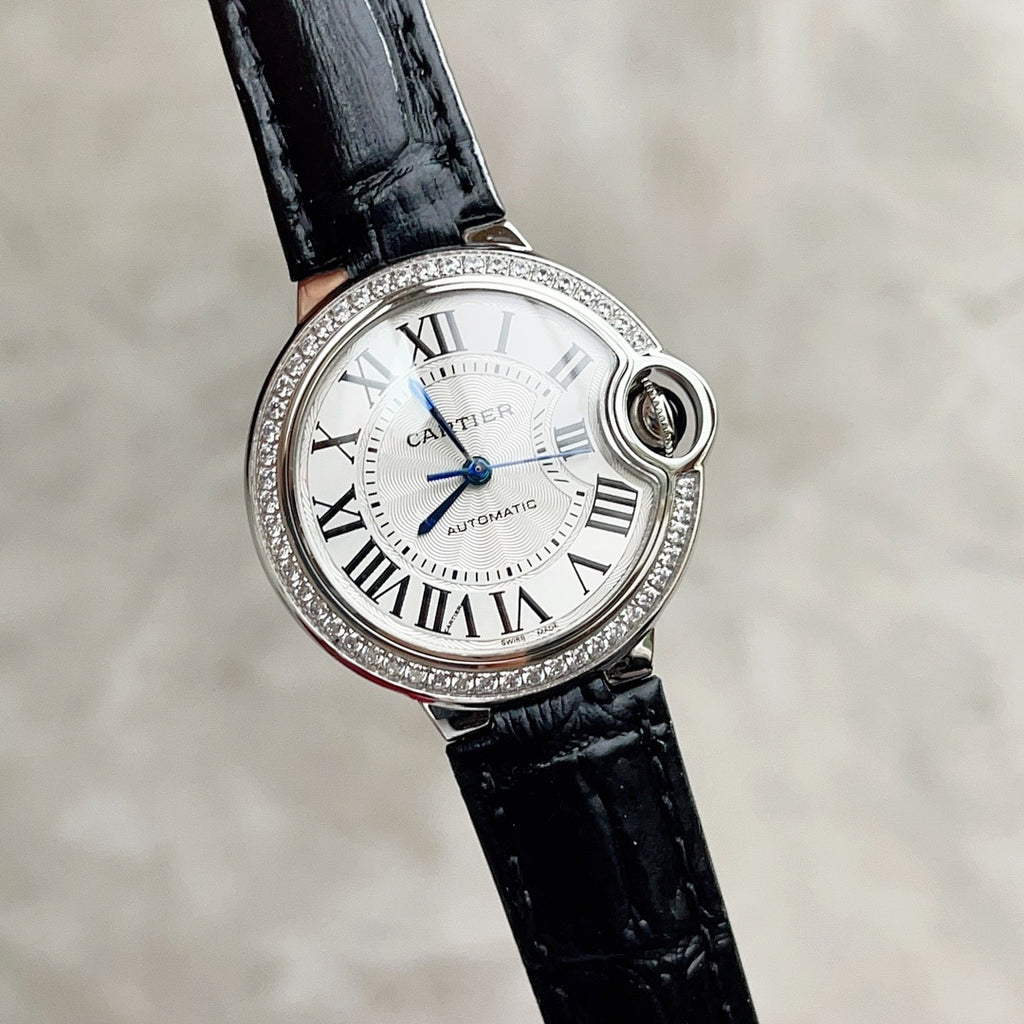 Cartier Ballon Bleu watch with black leather strap, white dial, blue hands, diamond bezel