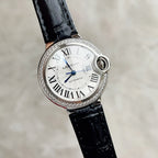 Cartier Ballon Bleu watch with black leather strap, white dial, blue hands, diamond bezel