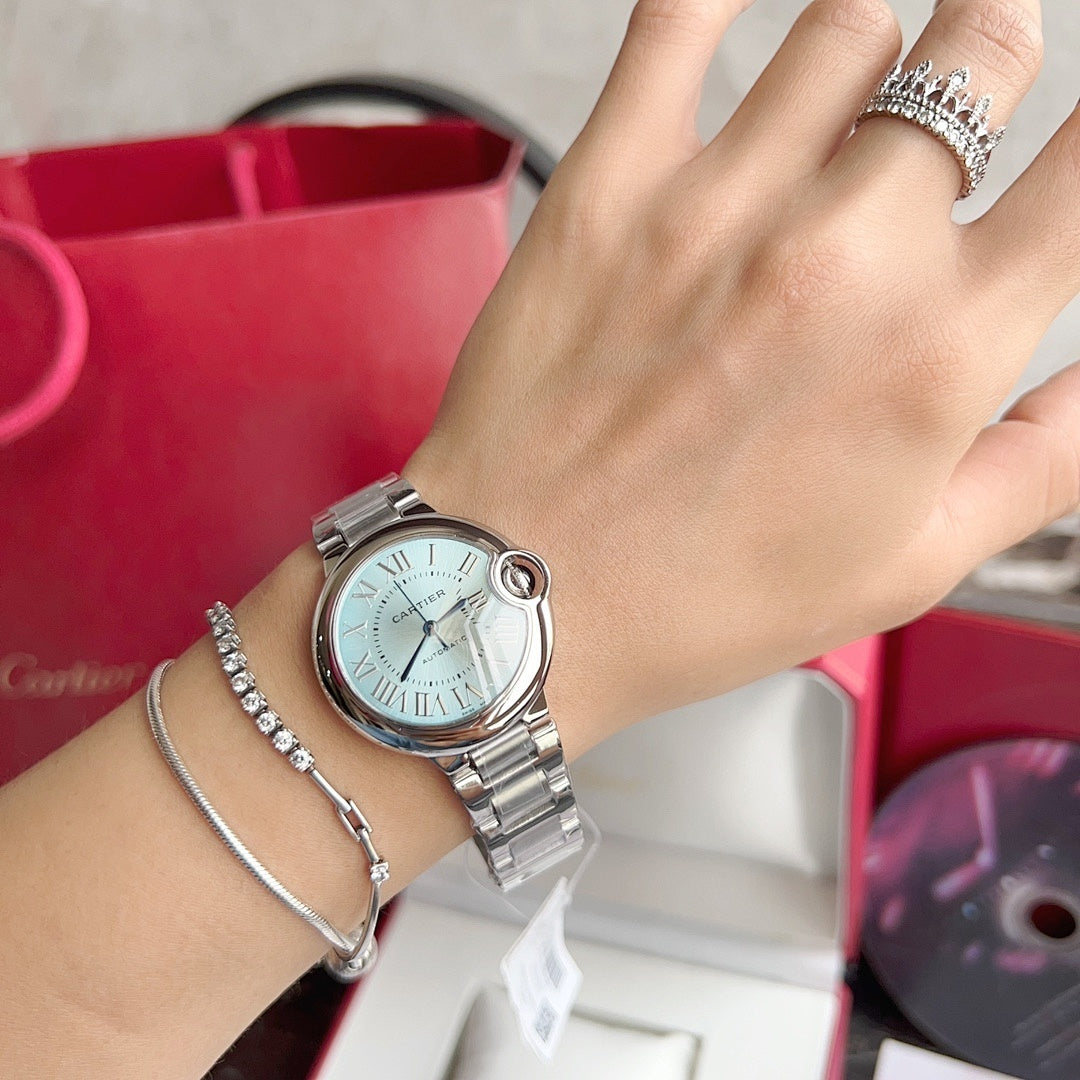 Cartier Ballon Bleu watch on wrist with light blue dial and silver link bracelet