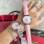 Pink leather-strap Cartier watch on wrist, round silver case, pink dial with Roman numerals