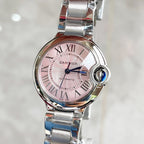 Stainless steel Cartier watch with pink dial, Roman numerals, blue cabochon crown