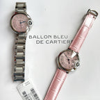 Two Cartier watches: steel-bracelet model and pink-leather strap model with pink dials