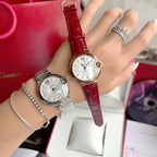 Two Ballon Bleu wristwatches: silver bracelet watch and red leather strap watch on a hand