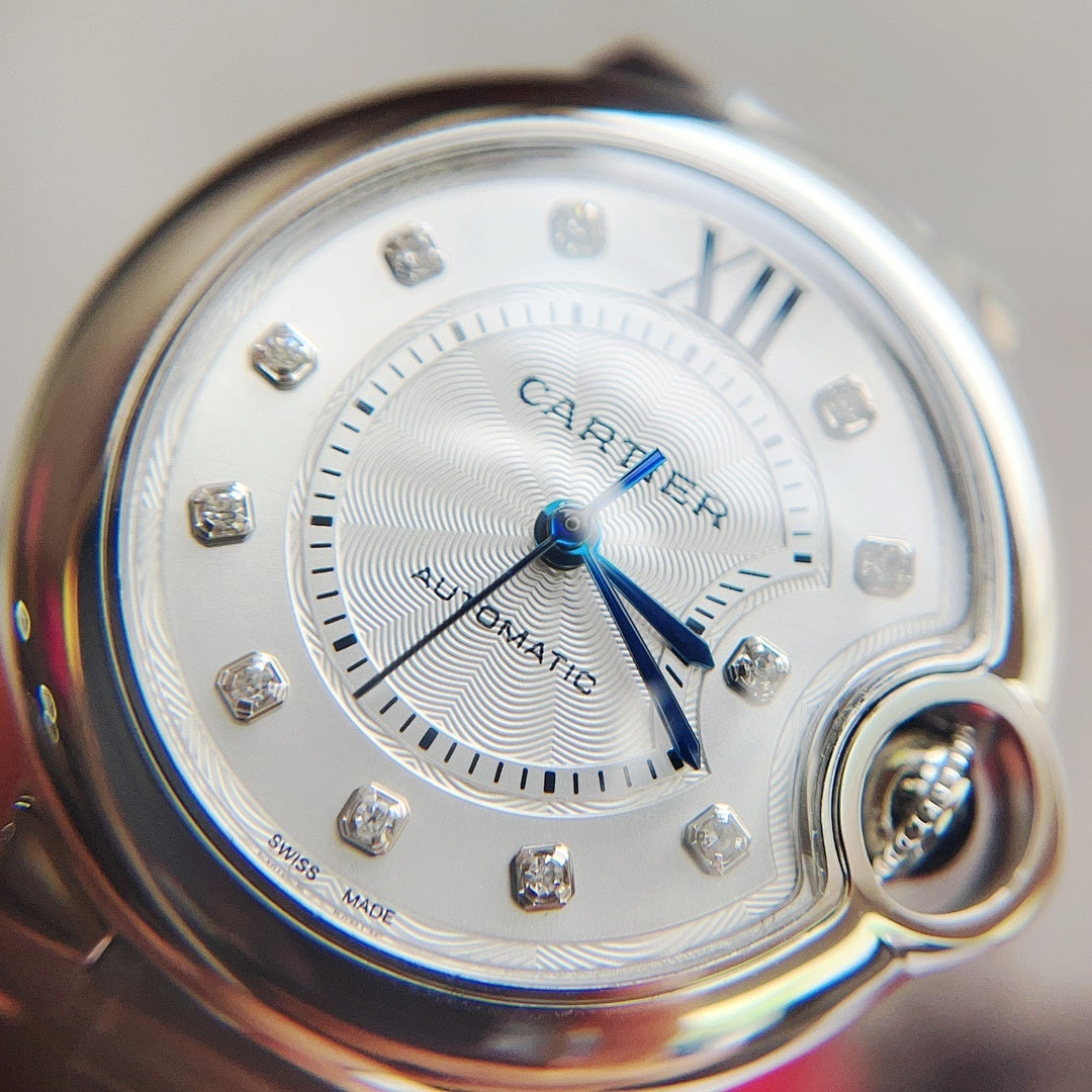 Close-up of Ballon Bleu watch dial with silver finish, blue hands, and diamond-like hour markers