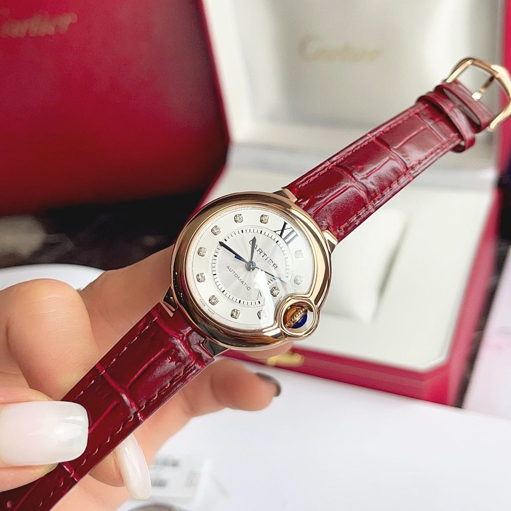 Rose-gold tone Ballon Bleu wristwatch with red leather strap and silver dial, blue hands