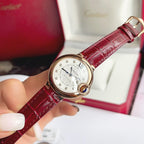 Rose-gold tone Ballon Bleu wristwatch with red leather strap and silver dial, blue hands