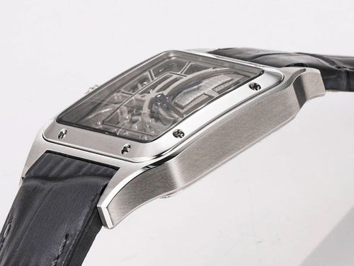 Cartier skeleton watch from the side, silver case with transparent dial and black leather strap