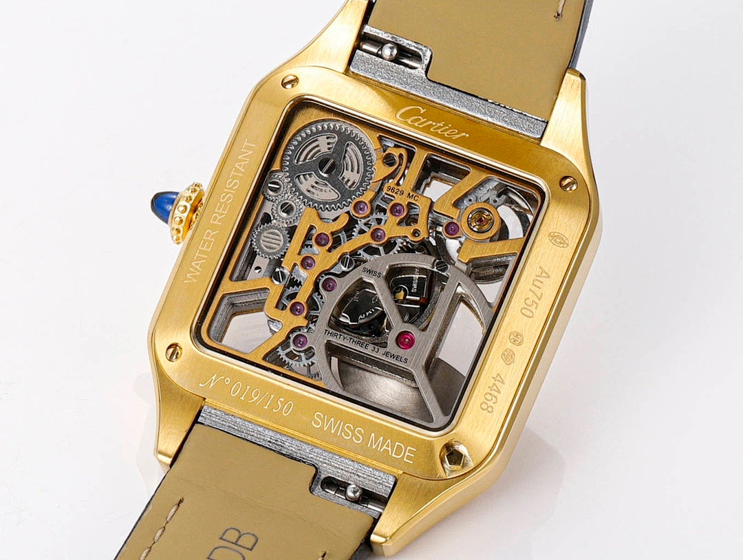 Gold-tone skeleton watch case detail with visible gears and dial, black leather strap