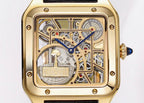 Front view of square gold-tone skeleton watch dial with blue hands and black leather strap