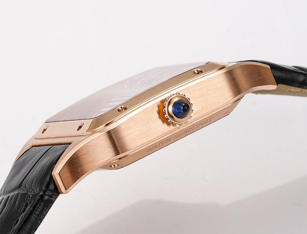 Cartier watch crown side, rose-gold case with blue jewel accent, black leather strap.