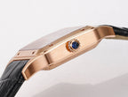 Cartier watch crown side, rose-gold case with blue jewel accent, black leather strap.