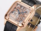Cartier watch angled dial view, rose-gold case, blue hands over skeleton movement, black strap.