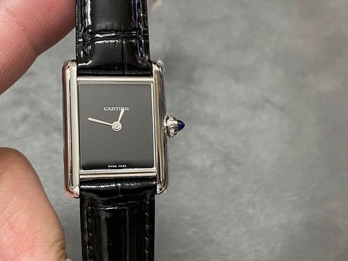 Cartier rectangular wristwatch on black leather strap, silver frame, dark dial and crown