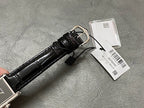Cartier watch strap view with black leather, silver buckle, and white barcode tag on back