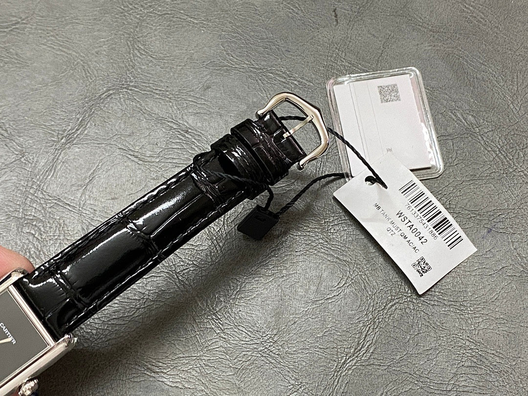 Cartier watch strap view with black leather, silver buckle, and white barcode tag on back