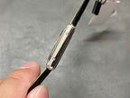 Cartier watch side profile with silver case and crown on black leather strap