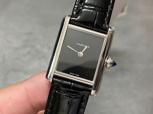 Cartier rectangular watch with black leather strap, silver case, dark dial and crown