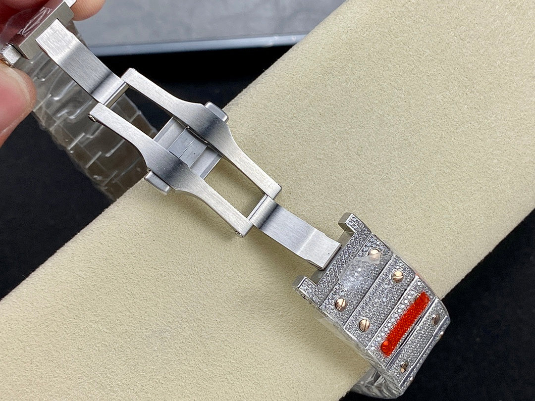 Silver metal wristwatch bracelet with rectangular diamond-set case and orange dial accents