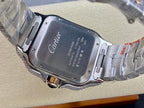 Silver metal wristwatch with engraved case back and Cartier logo on the dial