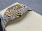 Cartier watch close-up with silver diamond case, gold trim around the square bezel and crown
