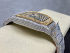Cartier watch side view with gold-trimmed bezel and textured silver case, diamond details