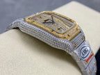 Rectangular blue dial watch with gold bezel, diamond border, and light gray bracelet