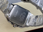 Cartier watch case back with engraved text and metal bracelet links on display