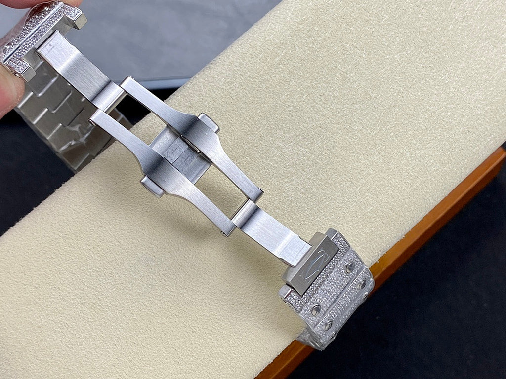 Cartier watch bracelet with silver-tone links and buckle, shown from side on a beige cushion.
