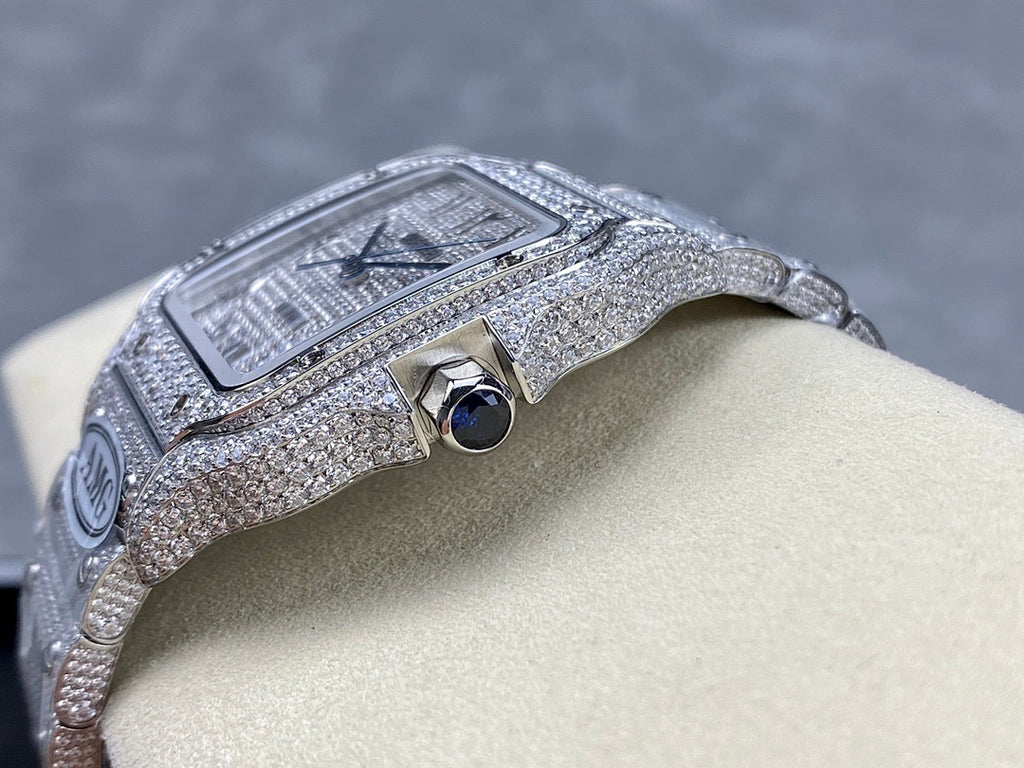 Cartier watch with diamond-studded bezel and crown, blue sapphire window, silver-tone strap.