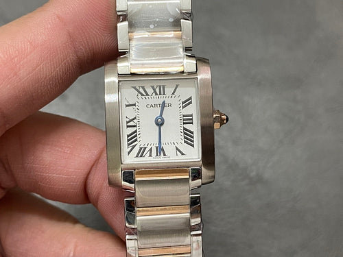 Cartier tank-style watch with silver dial, Roman numeral indexes, and metal bracelet