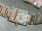 Cartier tank watch case back with engraved markings and metal bracelet, close-up