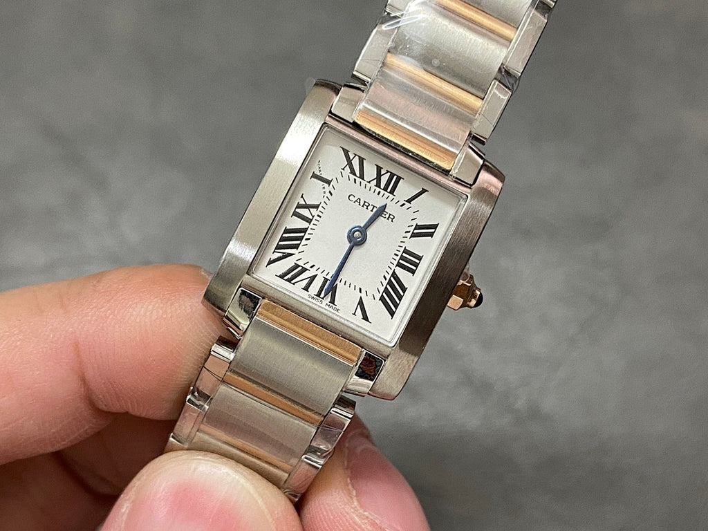 Cartier tank-style watch face with Roman numerals, blue hands, and silver metal bracelet