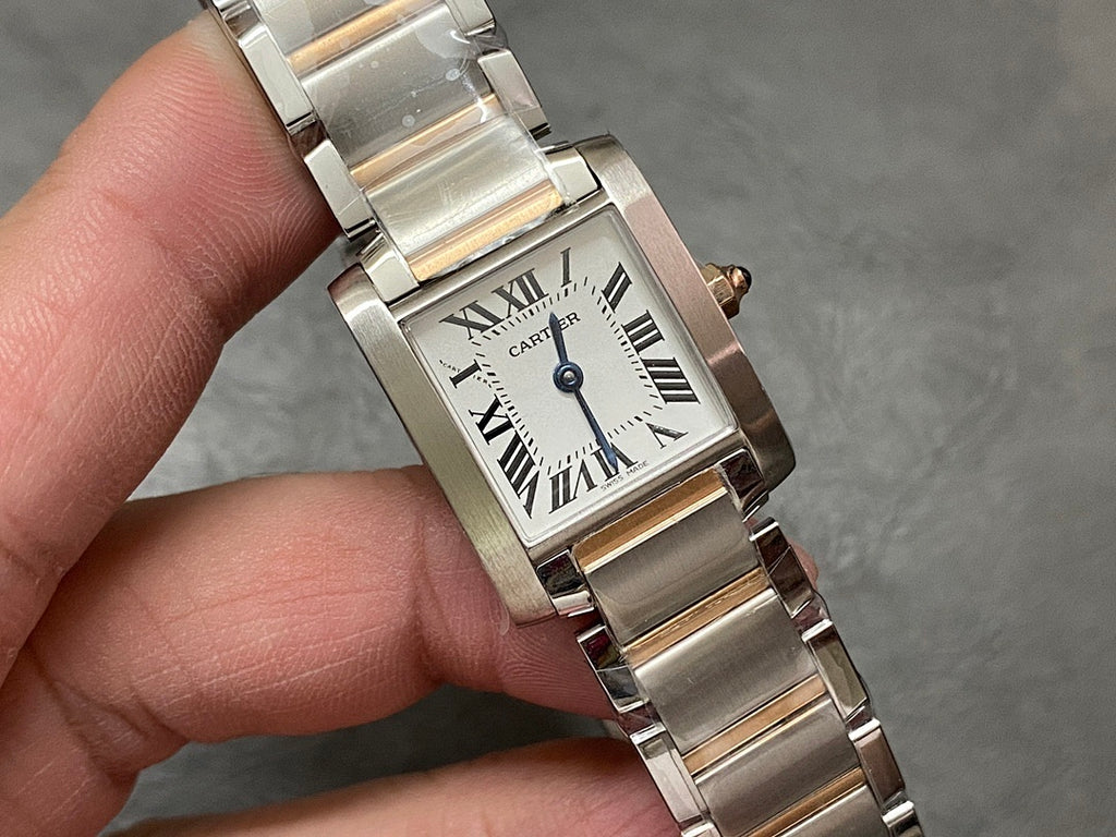 Cartier tank-style watch front close-up with Roman numeral dial and silver metal bracelet