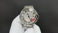 Cartier watch with silver dial, Roman numerals, blue hands, red A detail, steel bracelet