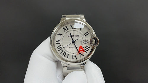 Cartier watch with silver dial, Roman numerals, blue hands, red A detail, steel bracelet