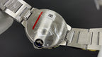Cartier watch caseback close-up on metal bracelet, with engraved back and crown-side details
