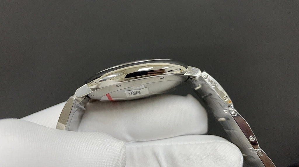 Cartier watch side profile with steel case, ridged crown, and link bracelet