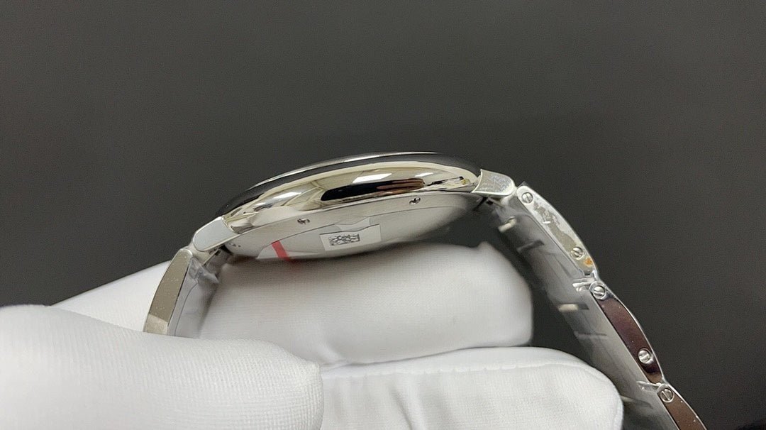 Cartier watch side profile with steel case, ridged crown, and link bracelet