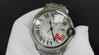Cartier watch dial front view in silver with Roman numerals, blue hands, red A mark